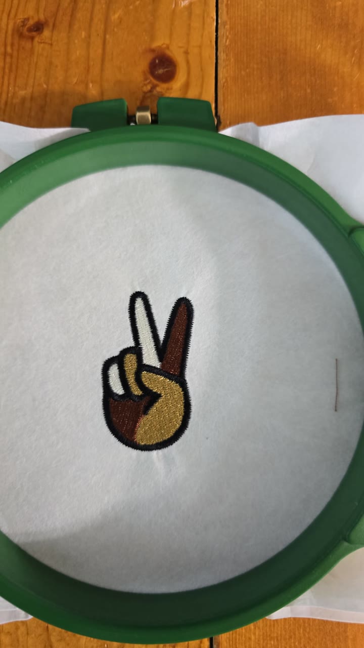 The peace hand, embroidered.